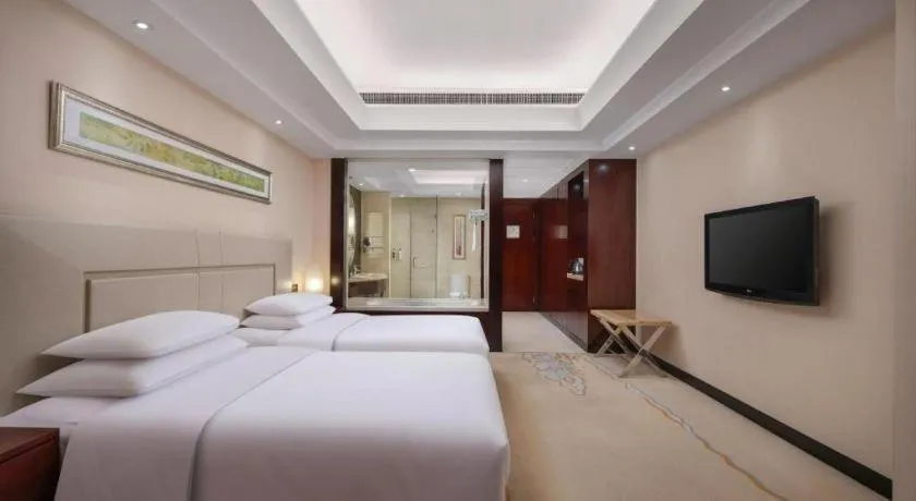 Bed in New Century Grand Changchun Hotel