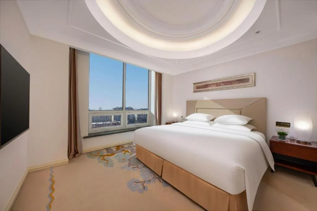 Bed in New Century Grand Changchun Hotel