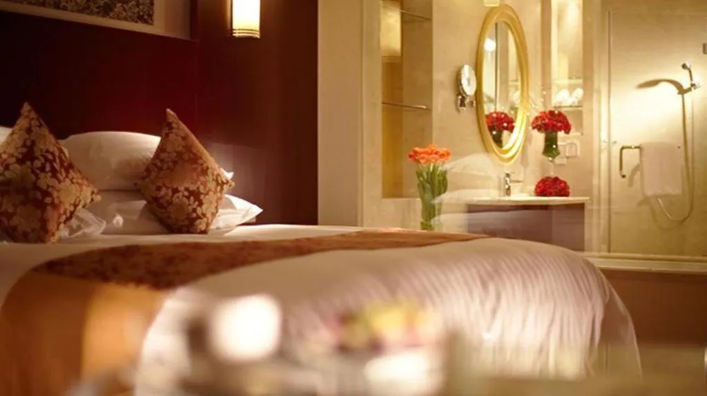 Bed in New Century Hotel Zaozhuang Fengming