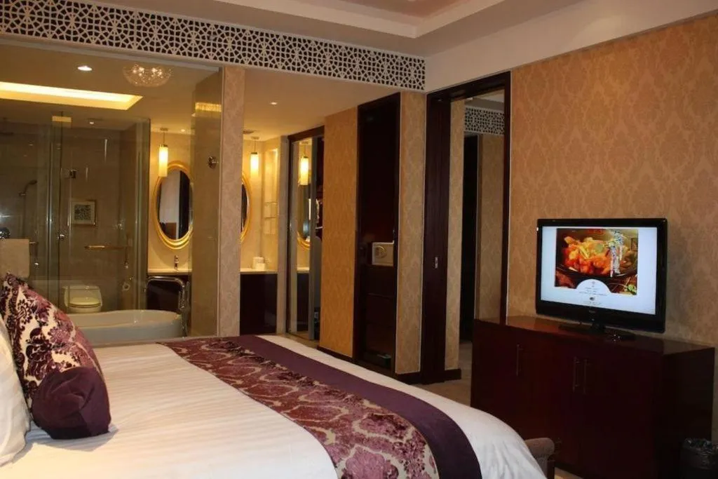 Bed in New Century Hotel Zaozhuang Fengming