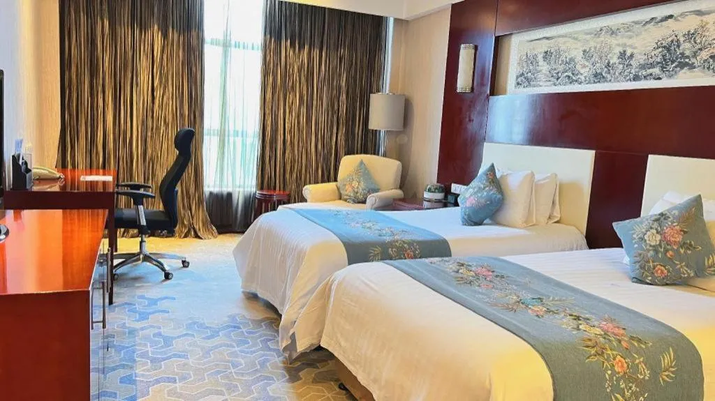Bed in New Century Hotel Zaozhuang Fengming
