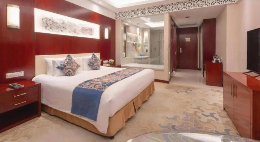 Bed in New Century Hotel Zaozhuang Fengming