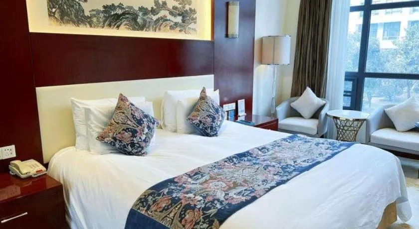 Bed in New Century Hotel Zaozhuang Fengming