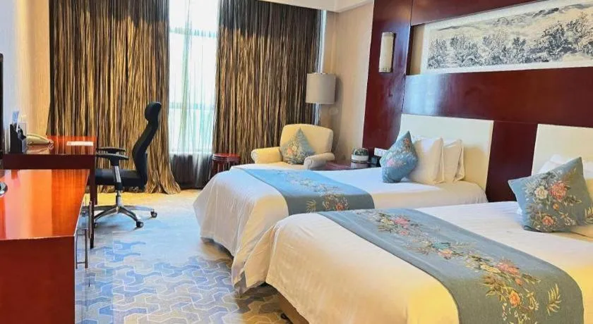 Bed in New Century Hotel Zaozhuang Fengming