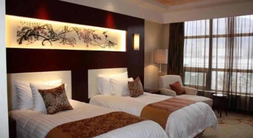 Bed in New Century Hotel Zaozhuang Fengming