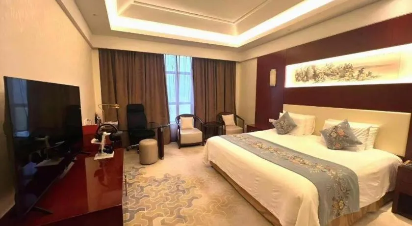 Bed in New Century Hotel Zaozhuang Fengming