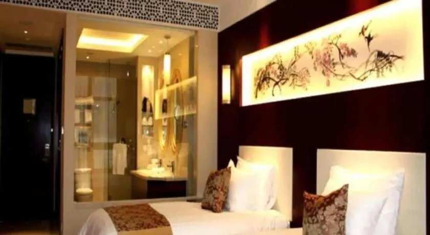 Bed in New Century Hotel Zaozhuang Fengming