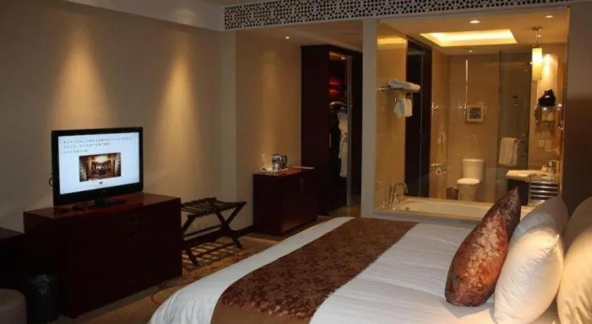 Bed in New Century Hotel Zaozhuang Fengming