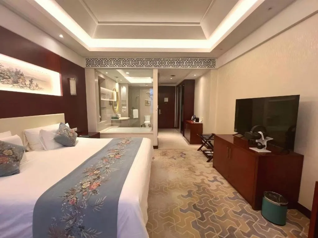 Bed in New Century Hotel Zaozhuang Fengming