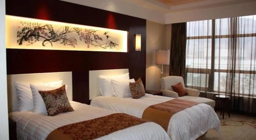 Bed in New Century Hotel Zaozhuang Fengming
