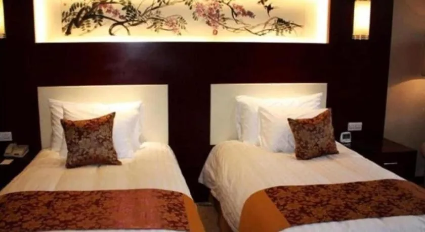 Bed in New Century Hotel Zaozhuang Fengming