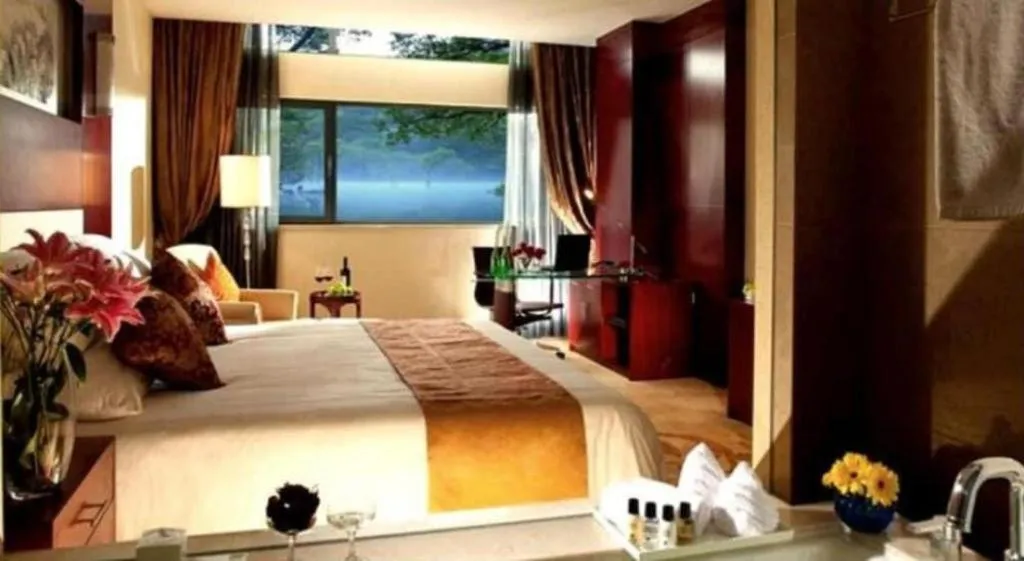 Bed in New Century Hotel Zaozhuang Fengming