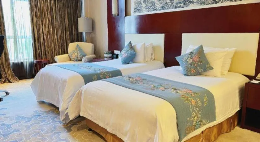 Bed in New Century Hotel Zaozhuang Fengming