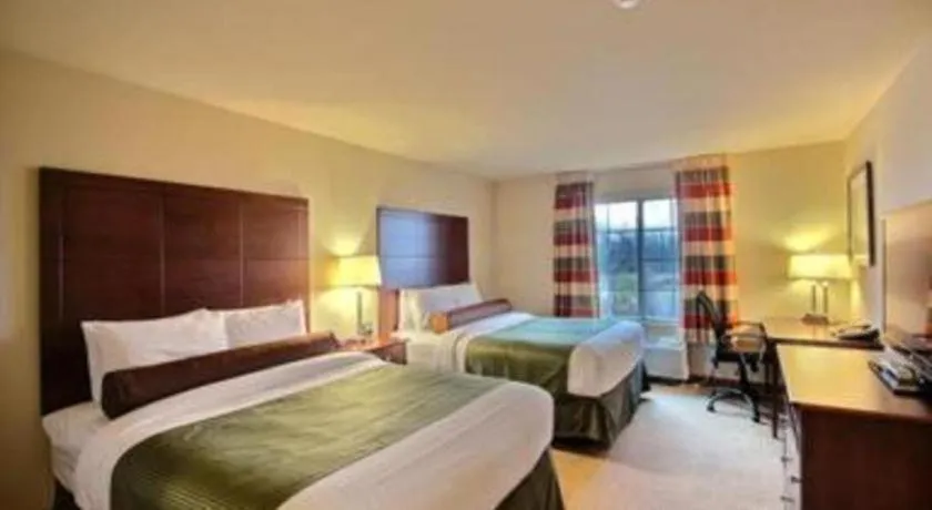 Bed in AmericInn by Wyndham Oshkosh