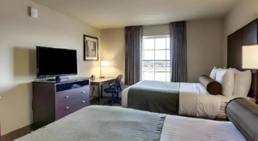 Bed in AmericInn by Wyndham Oshkosh