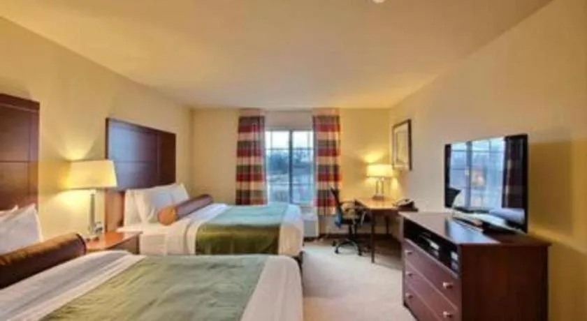 Bed in AmericInn by Wyndham Oshkosh