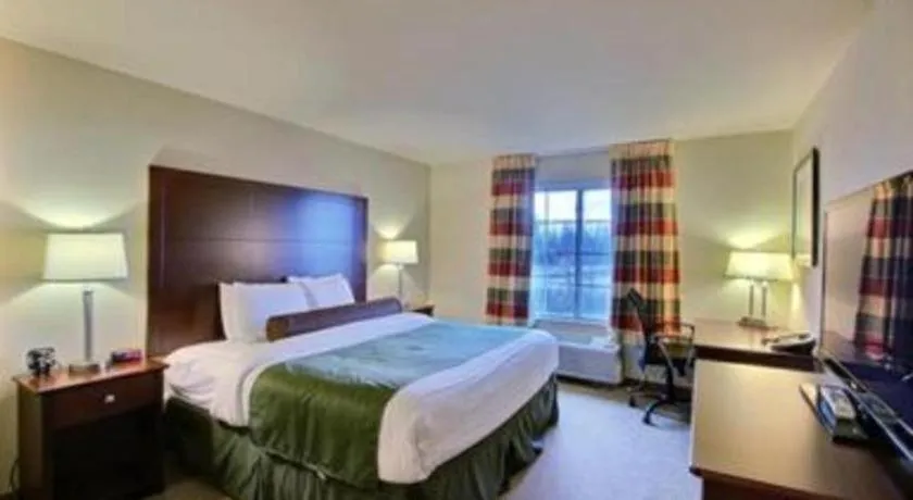 Bed in AmericInn by Wyndham Oshkosh