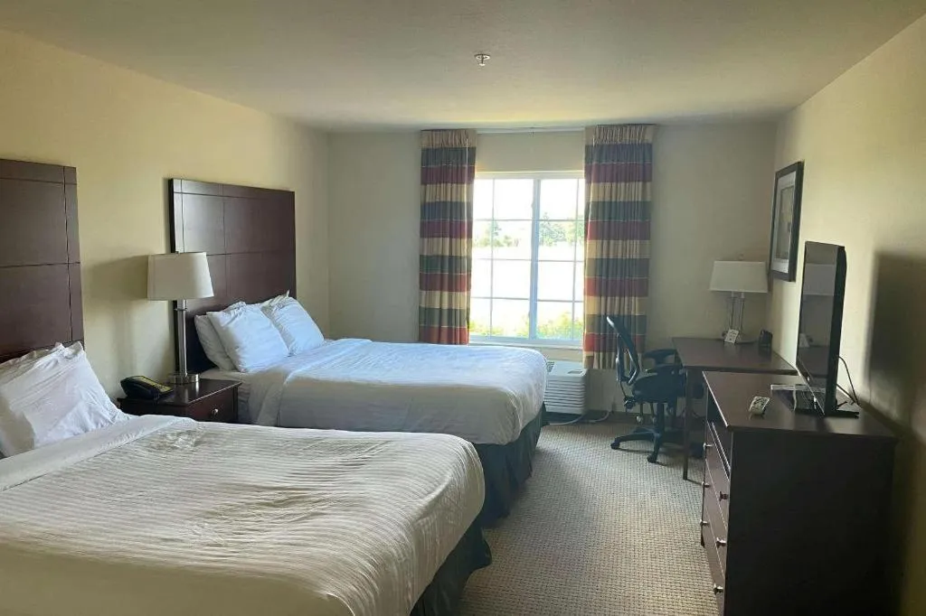 Bed in AmericInn by Wyndham Oshkosh