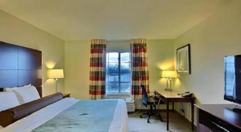 Bed in AmericInn by Wyndham Oshkosh