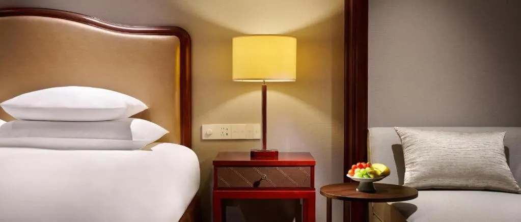 Bed in New Century Grand Hotel Zhejiang Sanli