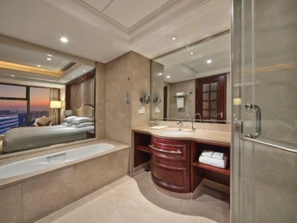 Bed in New Century Grand Hotel Zhejiang Sanli