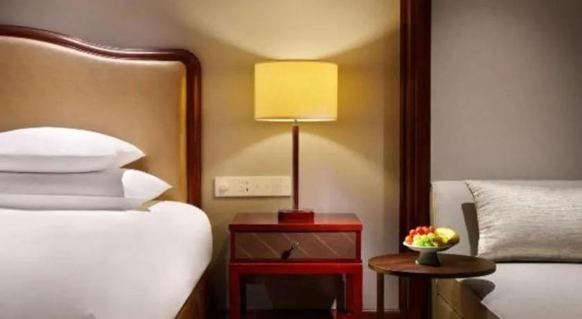 Bed in New Century Grand Hotel Zhejiang Sanli