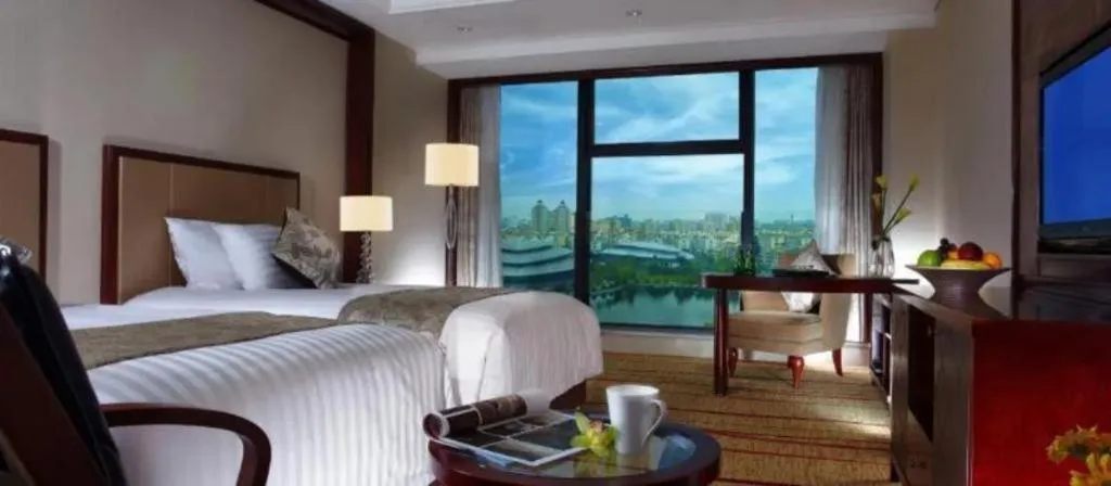 Bed in New Century Grand Hotel Zhejiang Sanli