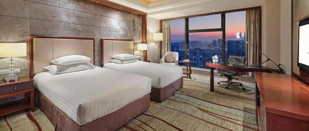 Bed in New Century Grand Hotel Zhejiang Sanli