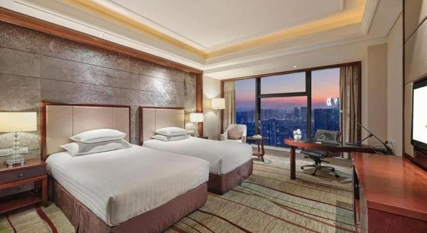 Bed in New Century Grand Hotel Zhejiang Sanli