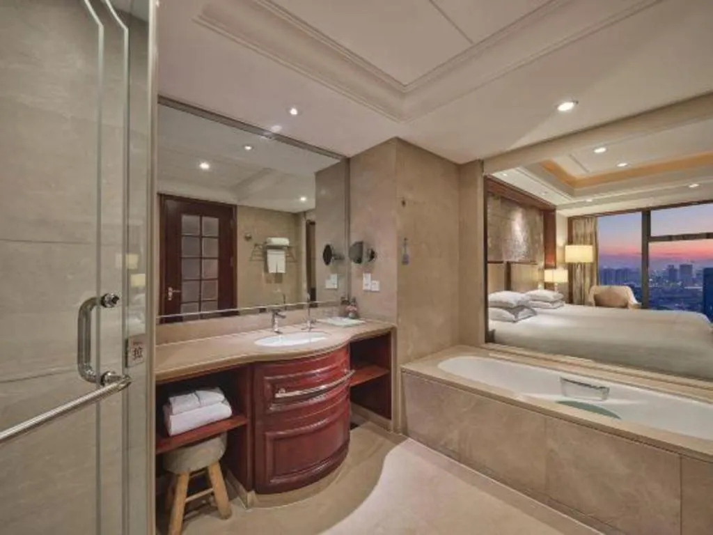 Bed in New Century Grand Hotel Zhejiang Sanli