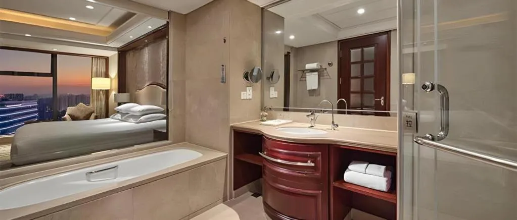 Bed in New Century Grand Hotel Zhejiang Sanli