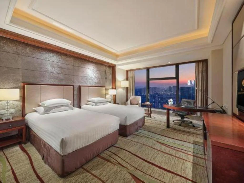 Bed in New Century Grand Hotel Zhejiang Sanli