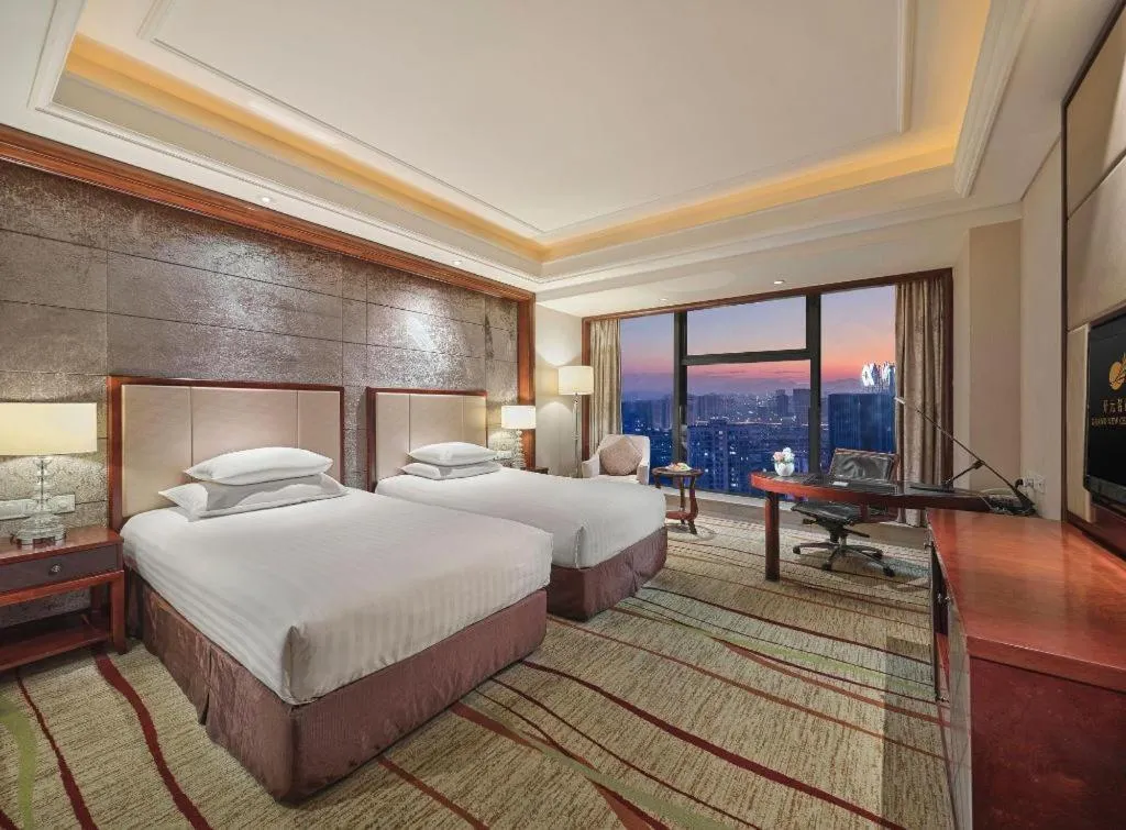 Bed in New Century Grand Hotel Zhejiang Sanli