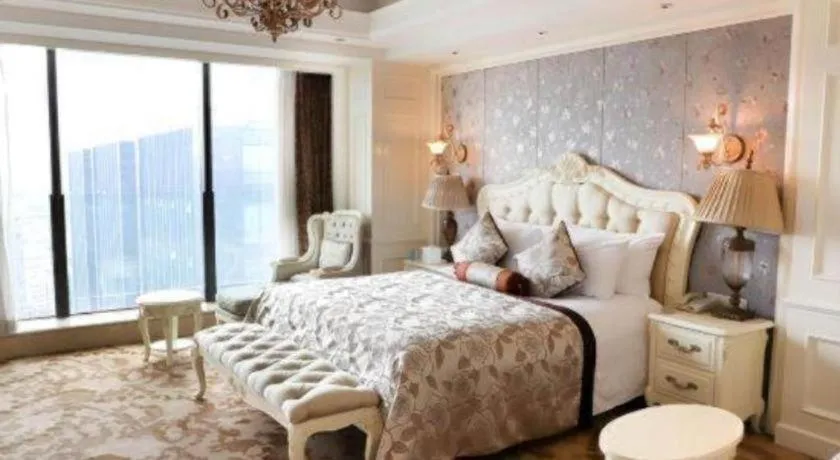 Bed in New Century Grand Hotel Zhejiang Sanli