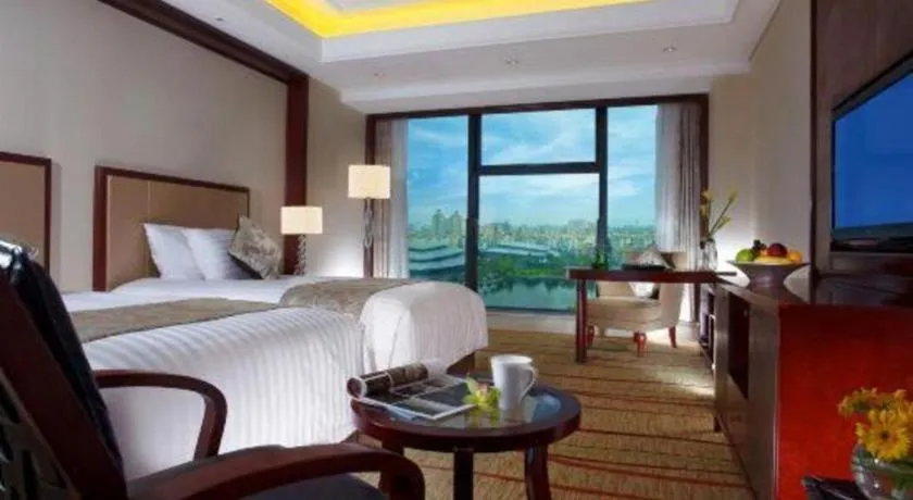 Bed in New Century Grand Hotel Zhejiang Sanli
