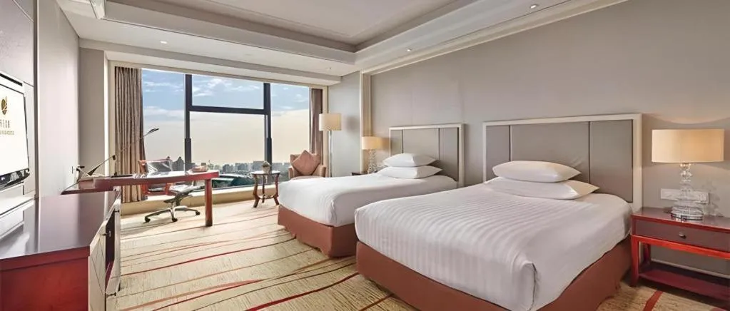 Bed in New Century Grand Hotel Zhejiang Sanli
