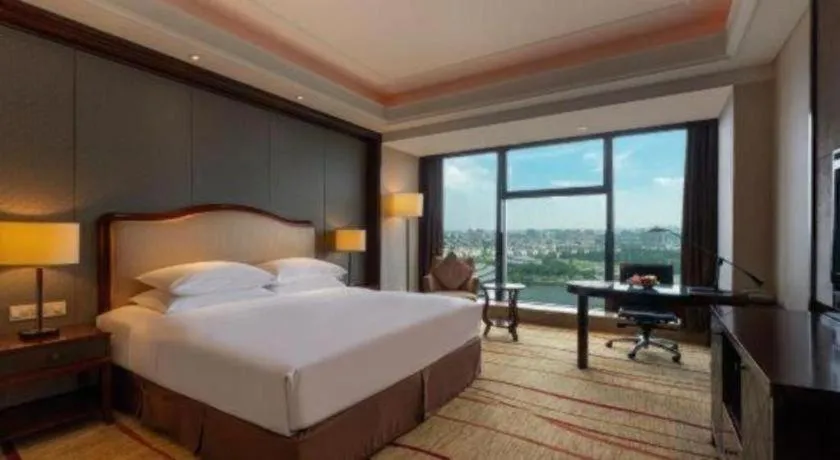 Bed in New Century Grand Hotel Zhejiang Sanli