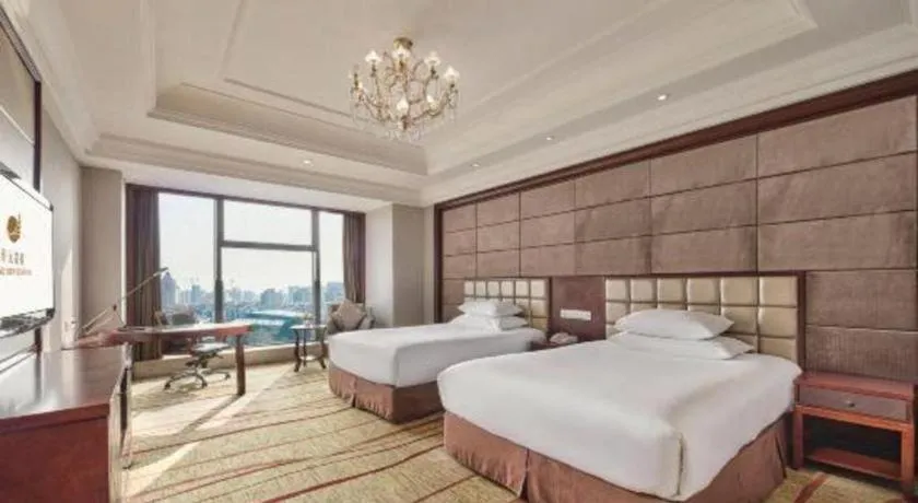 Bed in New Century Grand Hotel Zhejiang Sanli