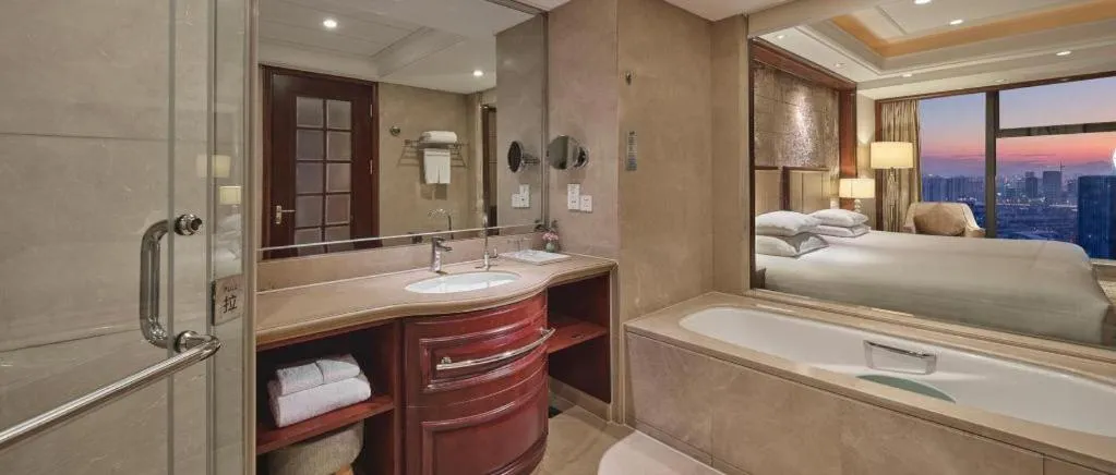 Bed in New Century Grand Hotel Zhejiang Sanli