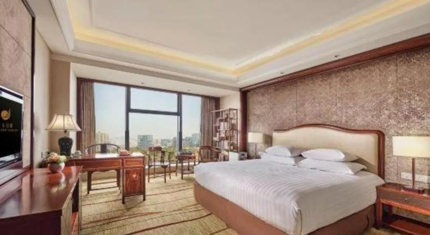 Bed in New Century Grand Hotel Zhejiang Sanli