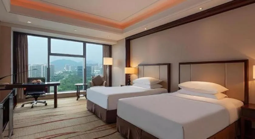 Bed in New Century Grand Hotel Zhejiang Sanli