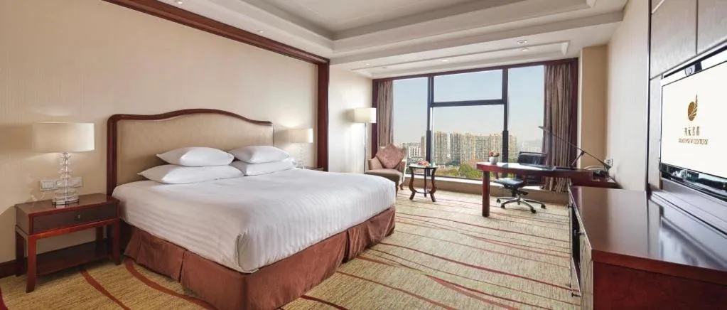 Bed in New Century Grand Hotel Zhejiang Sanli
