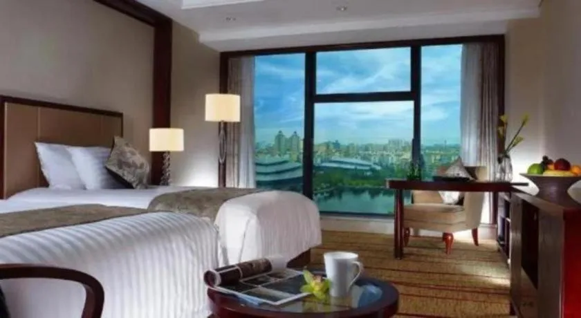 Bed in New Century Grand Hotel Zhejiang Sanli