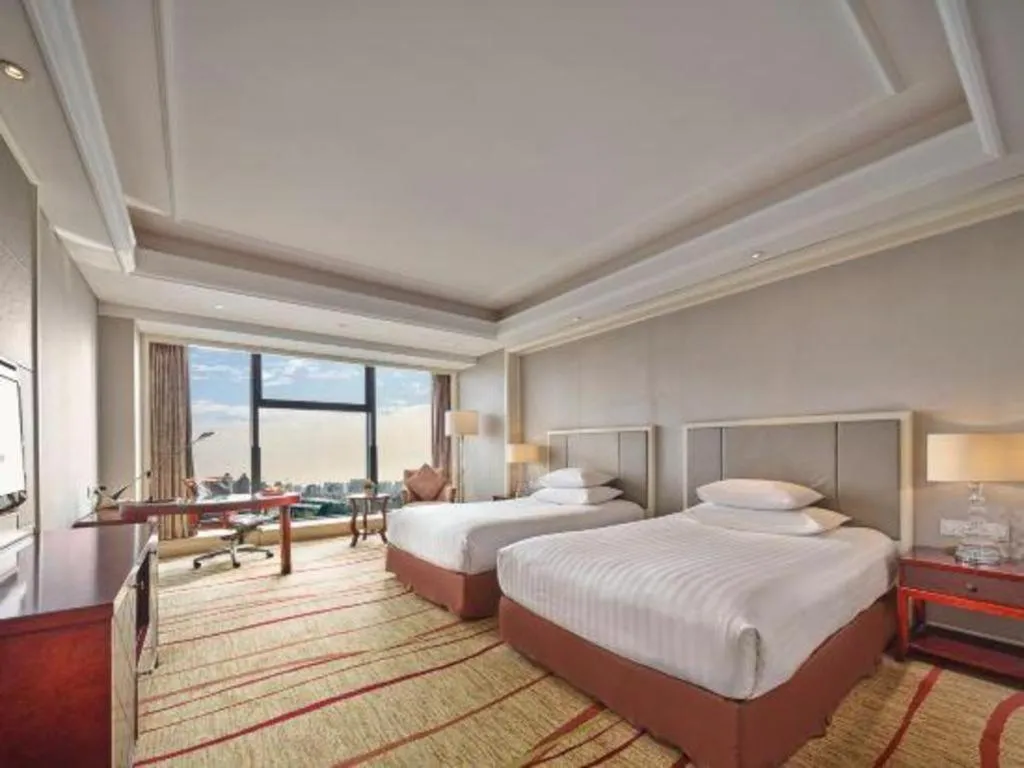Bed in New Century Grand Hotel Zhejiang Sanli