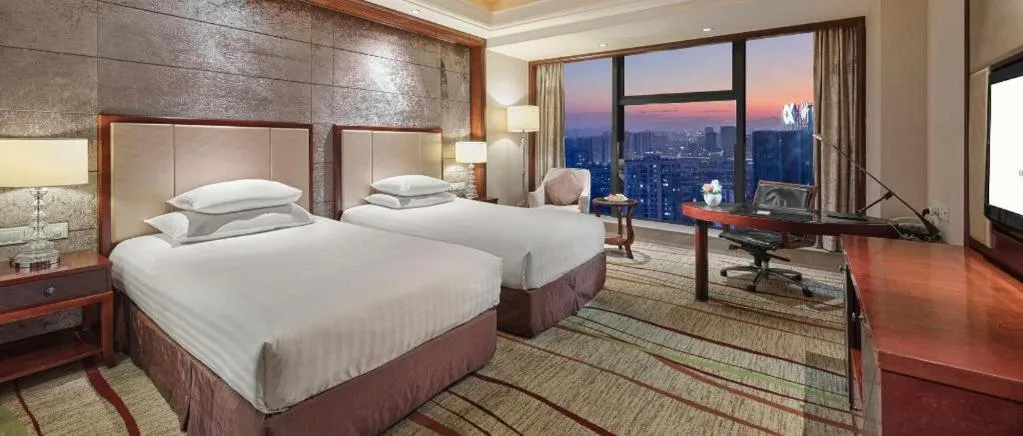 Bed in New Century Grand Hotel Zhejiang Sanli