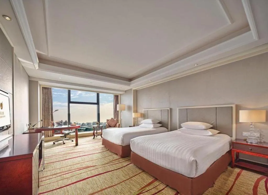 Bed in New Century Grand Hotel Zhejiang Sanli