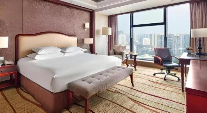 Bed in New Century Grand Hotel Zhejiang Sanli