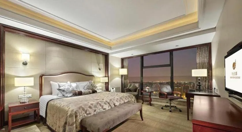 Bed in New Century Grand Hotel Zhejiang Sanli