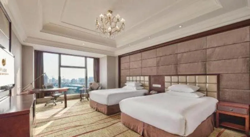 Bed in New Century Grand Hotel Zhejiang Sanli