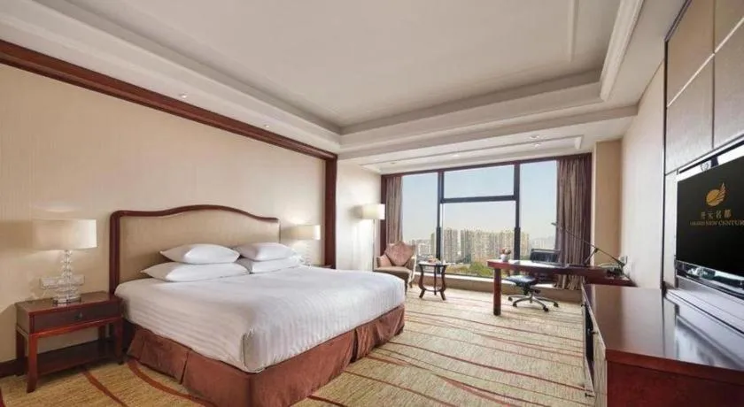 Bed in New Century Grand Hotel Zhejiang Sanli